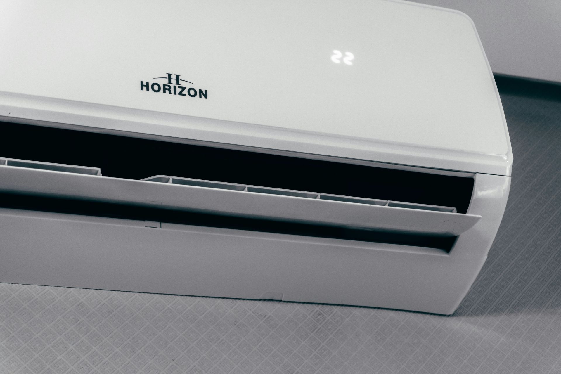 White air conditioner unit displaying 22 degrees